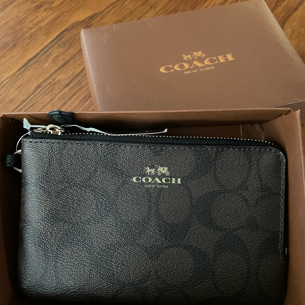 Brand new brown Coach wristlet.